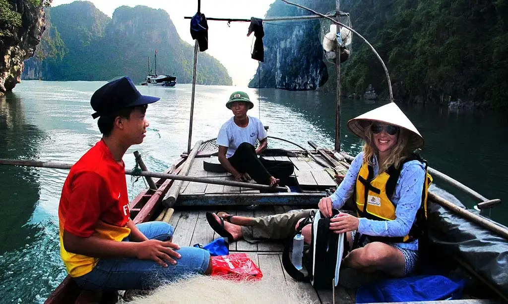 Traveler learning to fish on Halong Bay, Vietnam