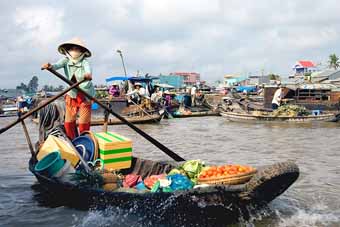 Rowing boat in the flaoting market on the Mekong River in Vietnam