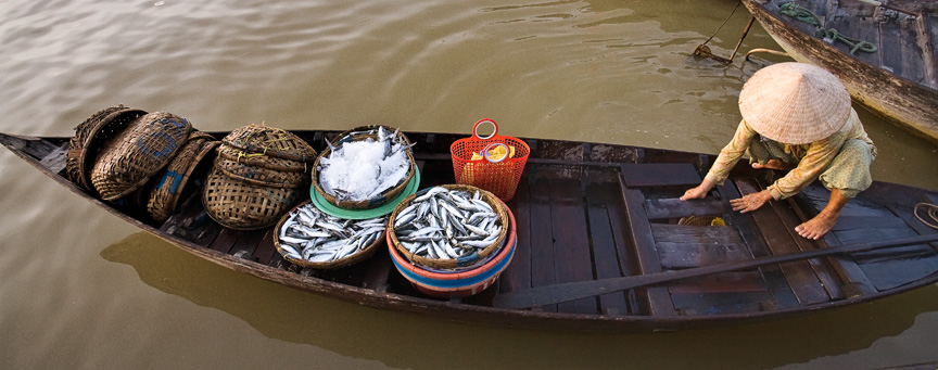 Fish vendor in Sampan near Halong Bay by Mark Tuschman